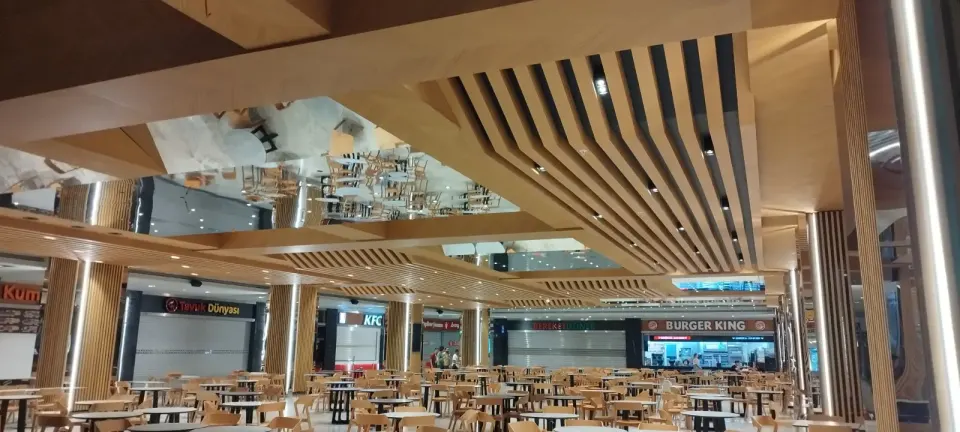 Slat-clad columns lining the counters under angled wooden ceiling beams